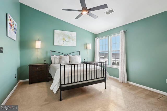 carpeted bedroom featuring ceiling fan and vaulted ceiling