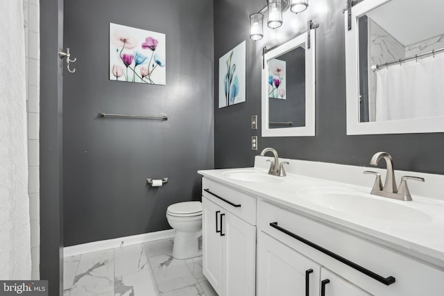 bathroom featuring toilet, vanity, and curtained shower