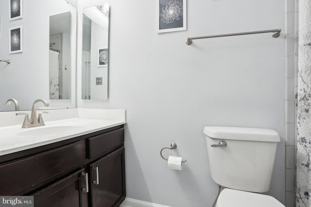 bathroom featuring toilet and vanity