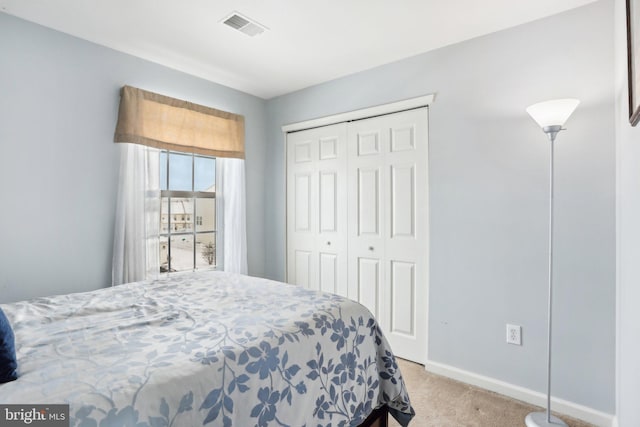 bedroom featuring a closet and light colored carpet