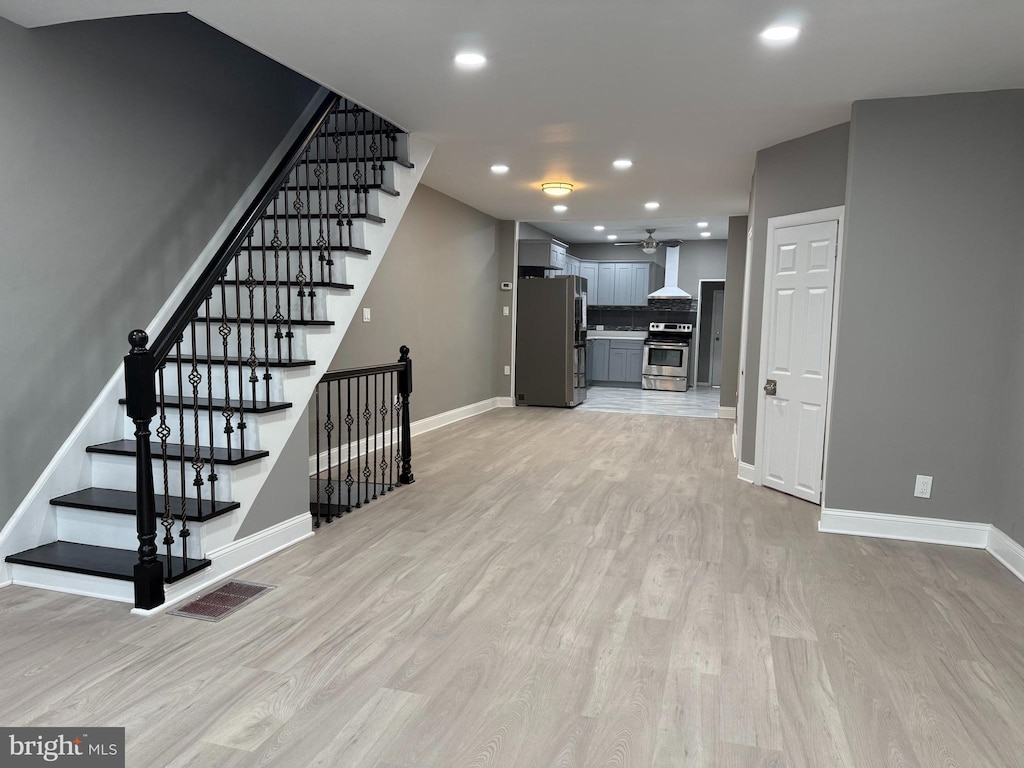 interior space with light wood-type flooring, visible vents, baseboards, and recessed lighting