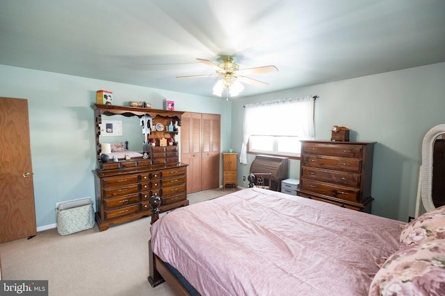 carpeted bedroom featuring ceiling fan and a closet