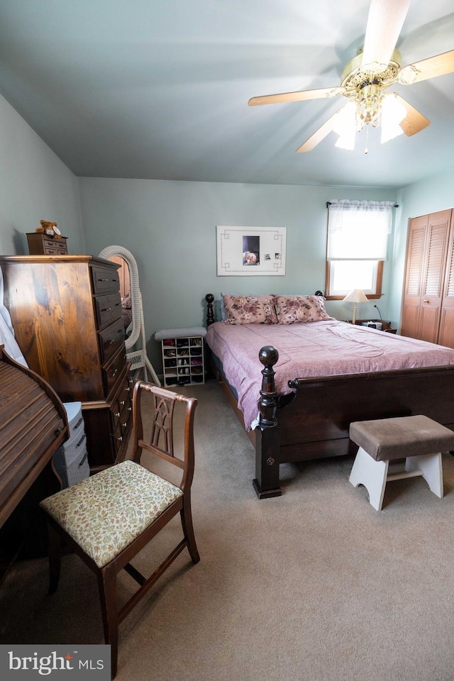 carpeted bedroom with ceiling fan and a closet