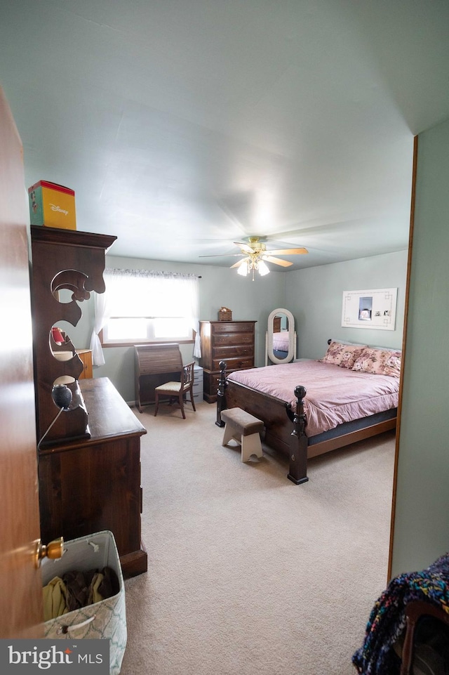 bedroom with ceiling fan and light colored carpet