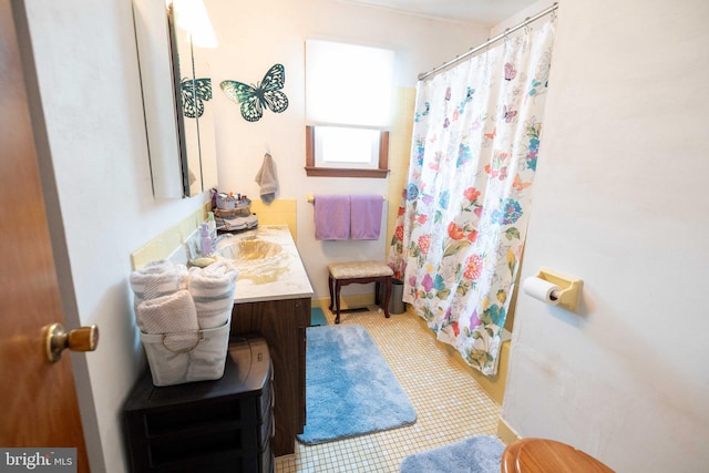 bathroom with tile patterned flooring and vanity