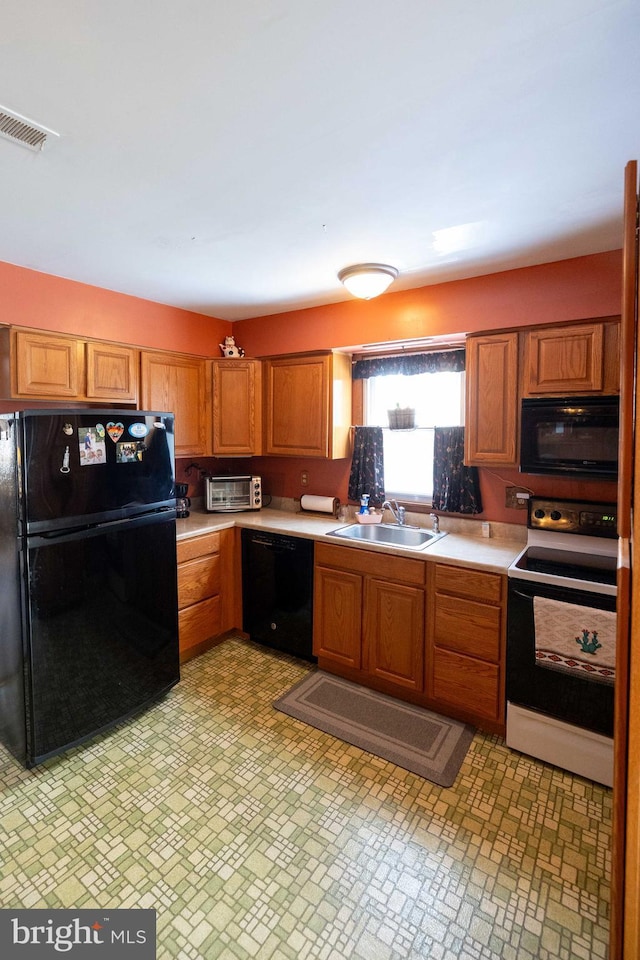 kitchen with sink and black appliances