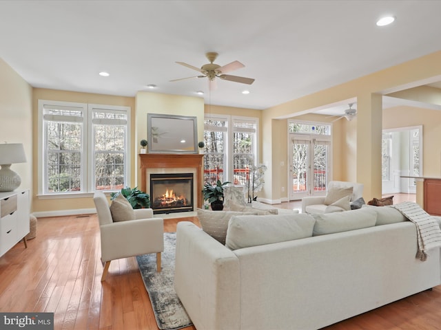 living room featuring ceiling fan and light wood-type flooring