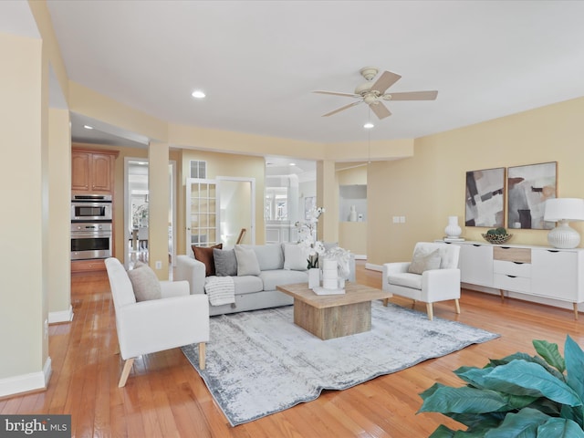 living room featuring ceiling fan and light wood-type flooring