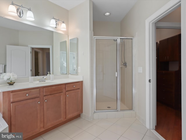 bathroom featuring vanity, an enclosed shower, and tile patterned floors