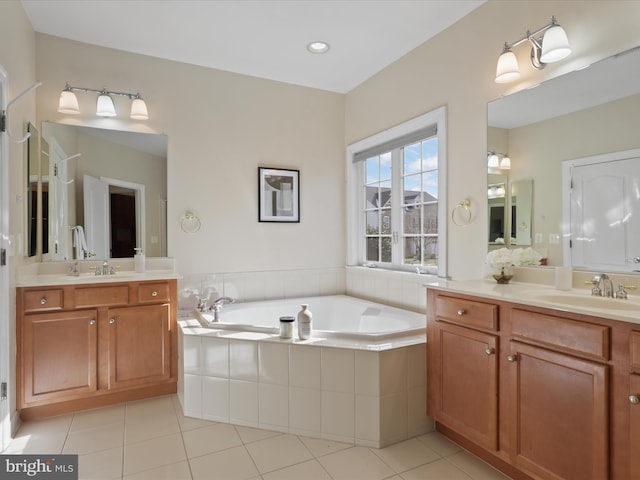 bathroom featuring vanity, tiled bath, and tile patterned floors