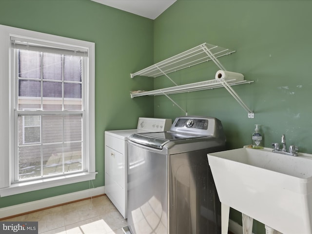 laundry area featuring separate washer and dryer and sink