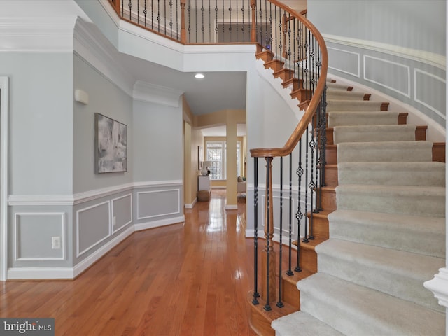 entryway featuring ornamental molding and hardwood / wood-style floors