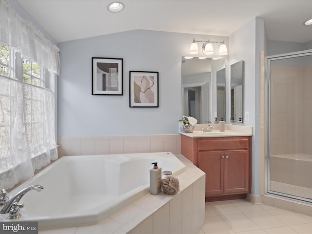 bathroom featuring tile patterned floors, plus walk in shower, vaulted ceiling, and vanity