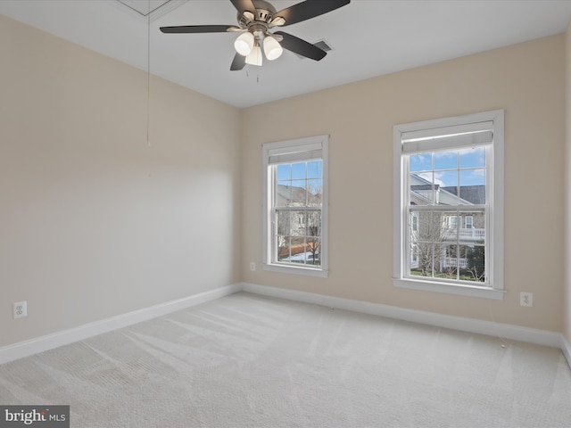 carpeted spare room with ceiling fan