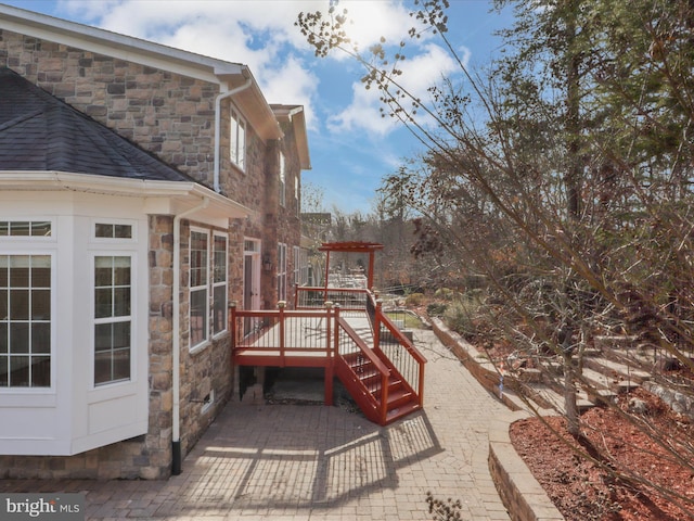 view of patio with a pergola and a deck