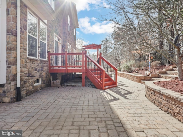 view of patio / terrace featuring a wooden deck and a pergola