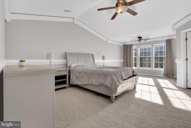 carpeted bedroom featuring lofted ceiling, ornamental molding, and ceiling fan