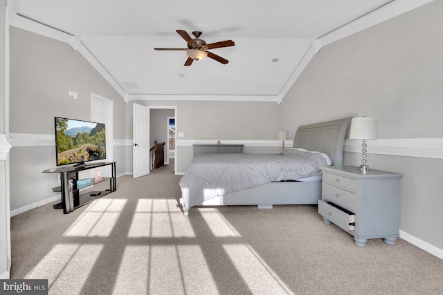 carpeted bedroom featuring crown molding, ceiling fan, and vaulted ceiling