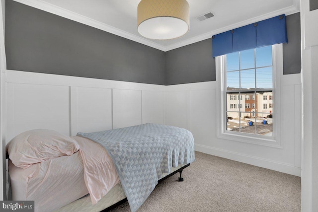 bedroom featuring crown molding and carpet flooring