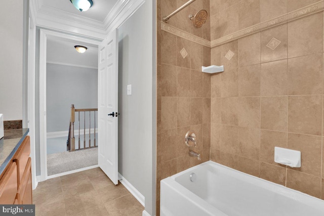 bathroom featuring vanity, ornamental molding, and tiled shower / bath