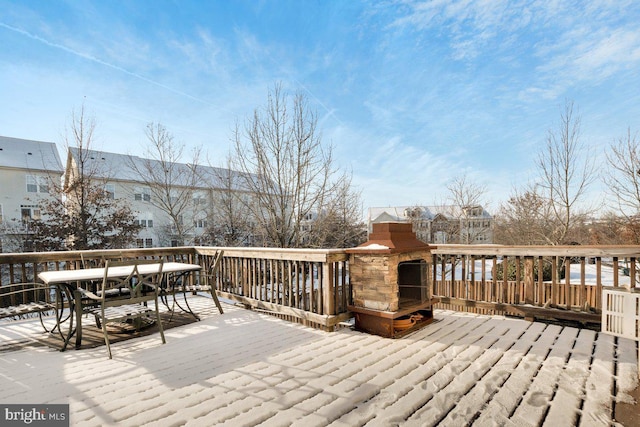 deck with an outdoor stone fireplace