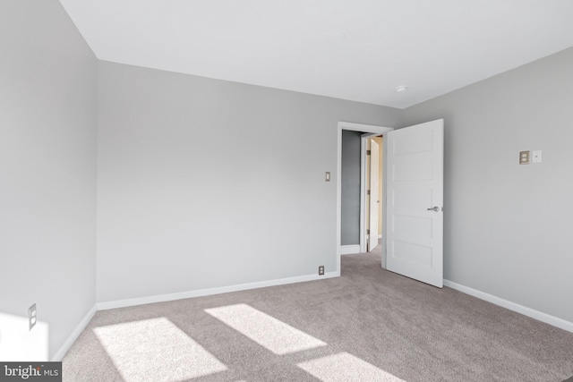 spare room with light colored carpet