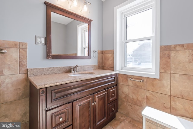 bathroom with tile walls, vanity, and tile patterned floors