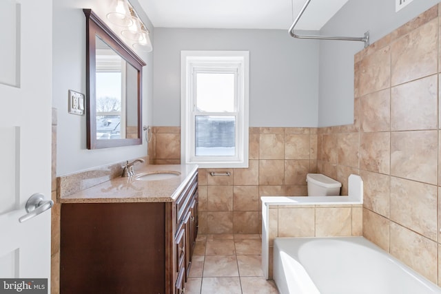 bathroom featuring tile patterned floors, vanity, toilet, and tile walls