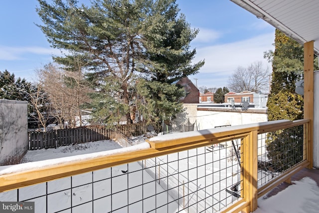 view of snow covered back of property