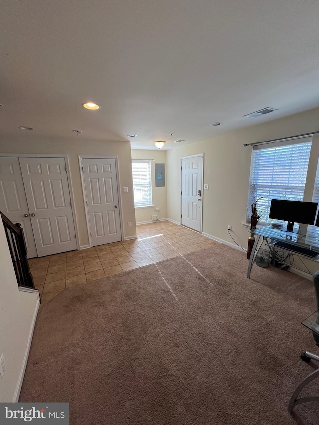 carpeted foyer featuring electric panel