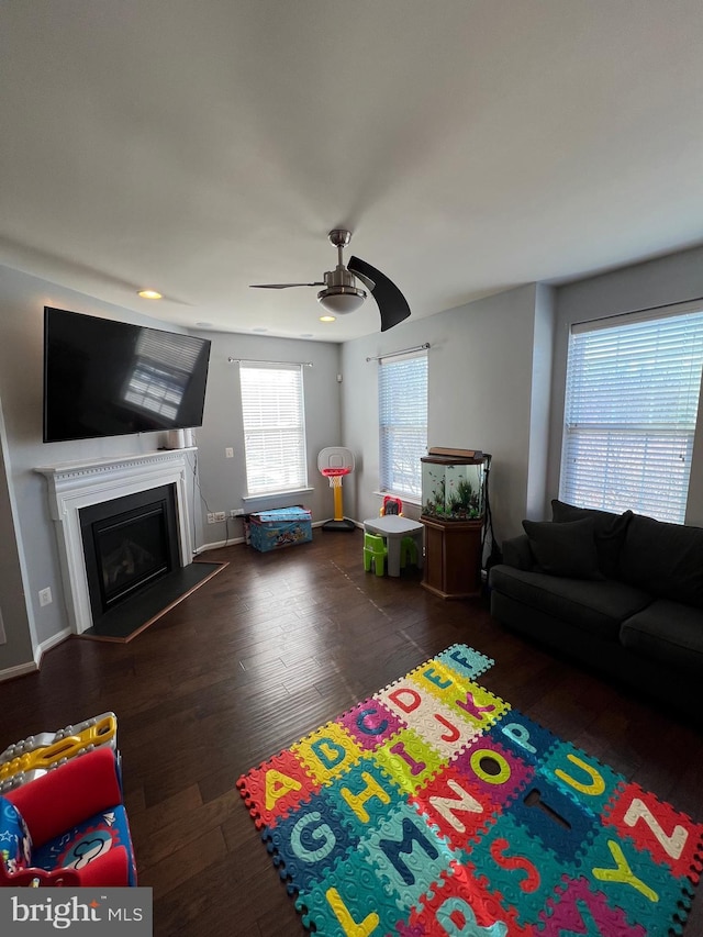 recreation room featuring ceiling fan and dark hardwood / wood-style flooring