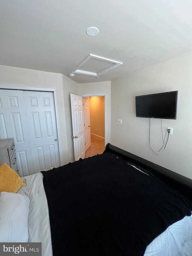 bedroom with light carpet and a closet