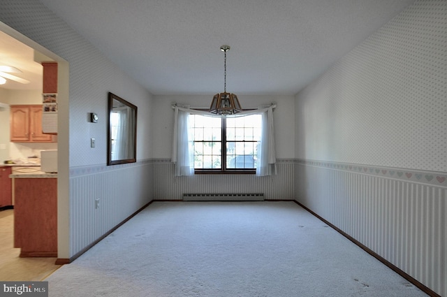 unfurnished dining area featuring light colored carpet, ceiling fan, and baseboard heating