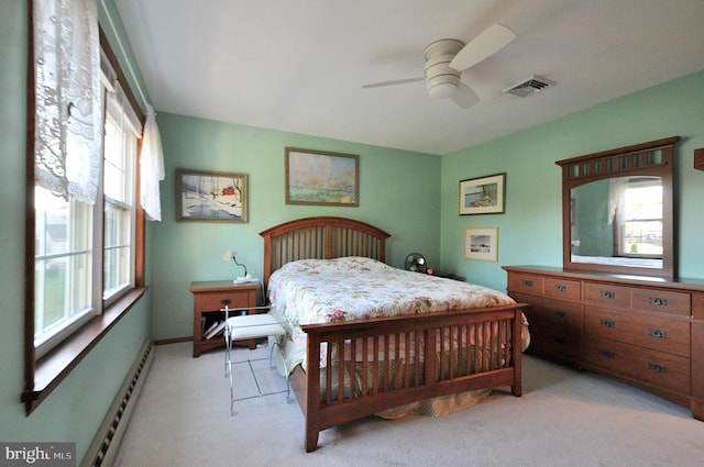 bedroom with multiple windows, a baseboard radiator, light carpet, and ceiling fan