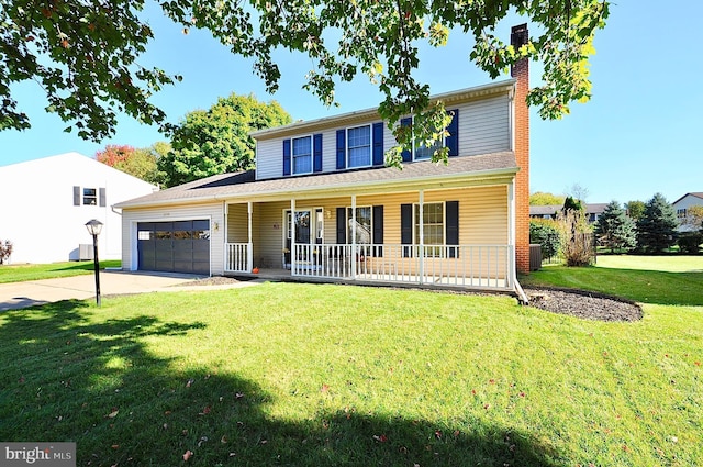 view of front of house with a garage, a front yard, and a porch