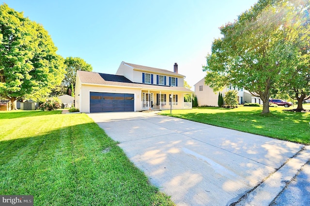 view of front of house with a garage, a front yard, and a porch