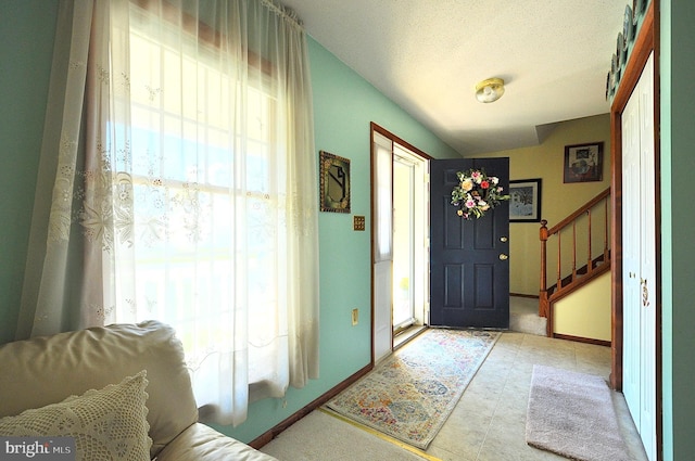 foyer entrance featuring a wealth of natural light and a textured ceiling