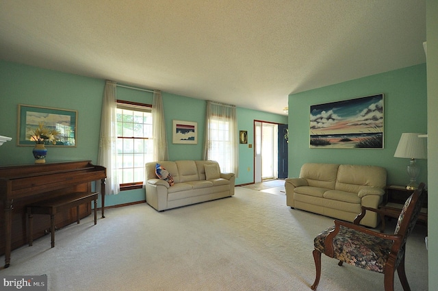 living room with light carpet and a textured ceiling