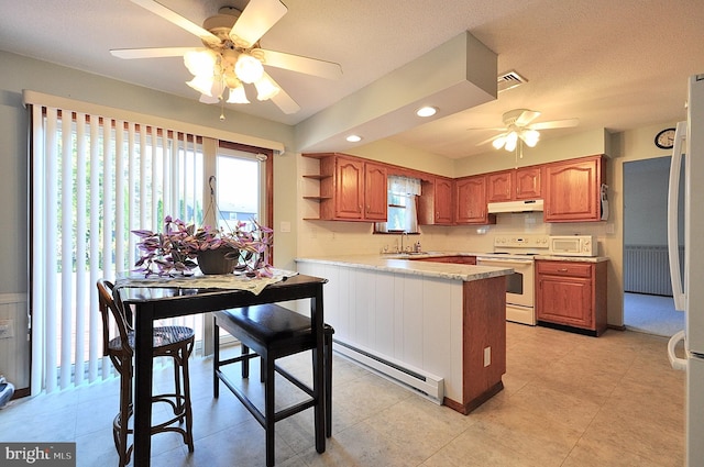 kitchen featuring sink, white appliances, a baseboard heating unit, backsplash, and kitchen peninsula