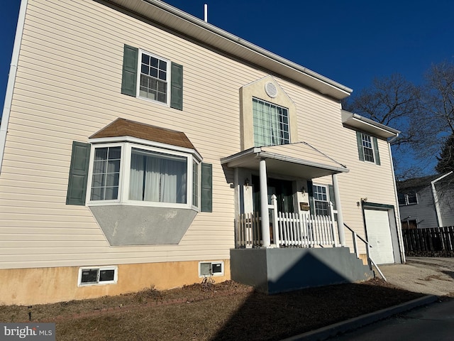 front facade with a porch and a garage