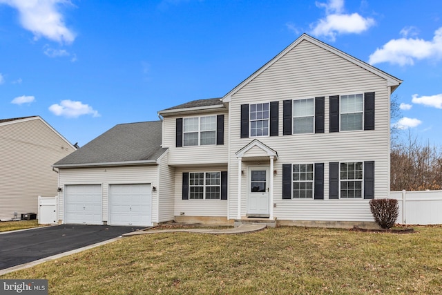 view of front of property with a garage and a front lawn