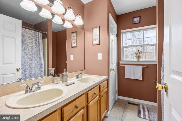 bathroom featuring toilet, vanity, and tile patterned floors