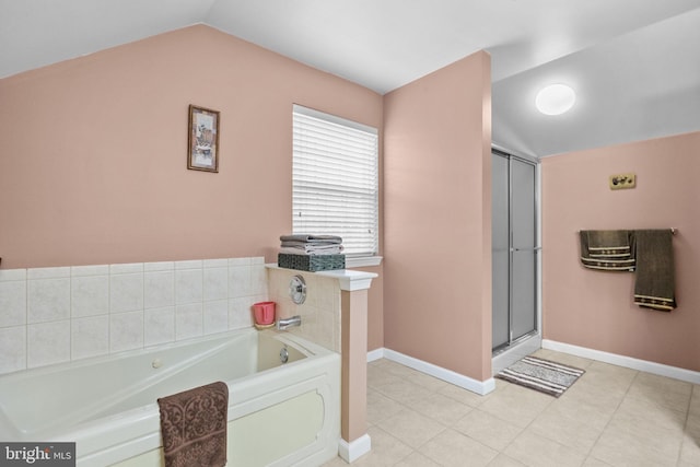 bathroom with a bathing tub and vaulted ceiling