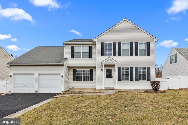 view of front of house featuring a front lawn and a garage