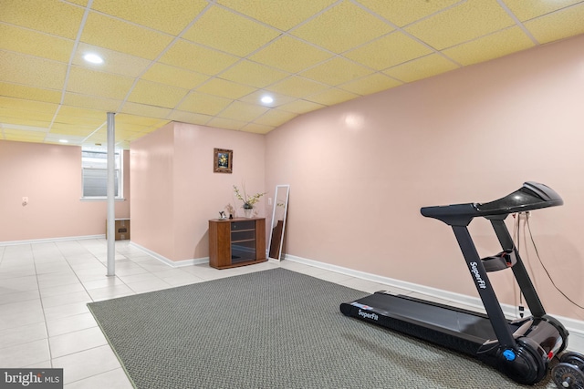 exercise area featuring tile patterned floors and a paneled ceiling