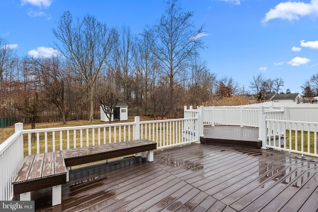 wooden deck with a lawn and a shed