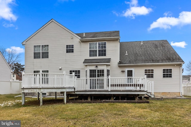 back of property featuring a deck and a yard