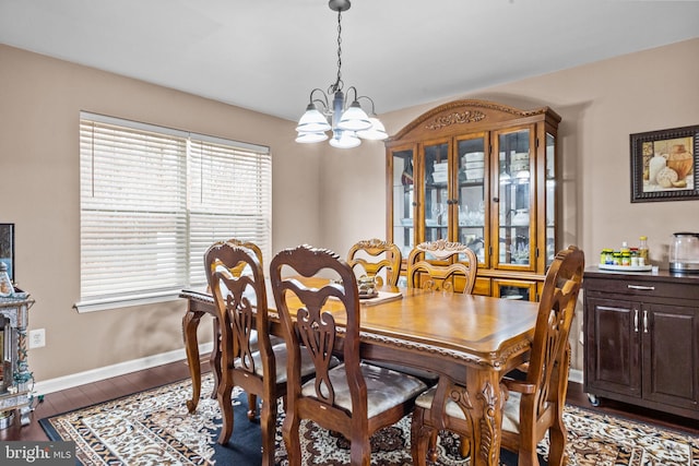 dining room featuring a notable chandelier and dark hardwood / wood-style floors