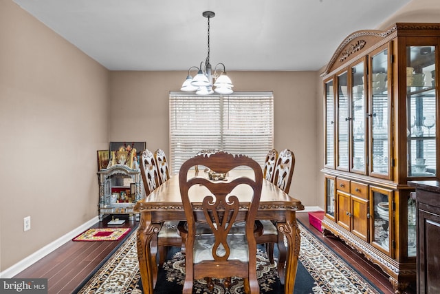 dining area featuring a chandelier and wood-type flooring