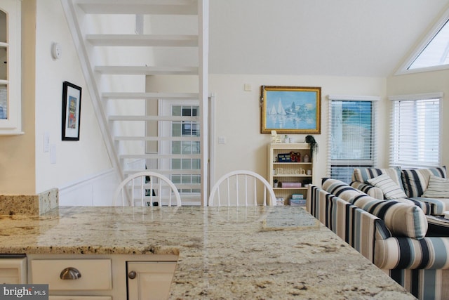 dining area featuring vaulted ceiling